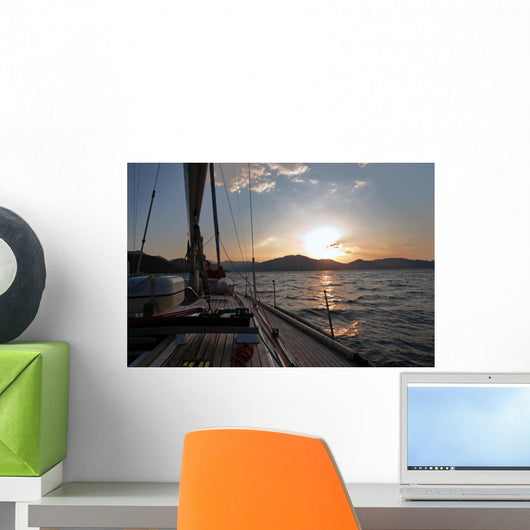 Sailing boat in the sea at sunset Wall Mural