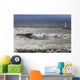 Storm waves crashing on a beach near a lighthouse on lake ontario Wall Mural