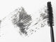 Mascara brush leaving traces of mascara on a white background Wall Decal