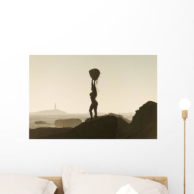 Silhouette Female Surfer Wall Decal shown on a wall