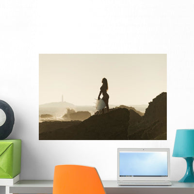 Silhouette Female Surfer Holding Wall Mural shown on a wall