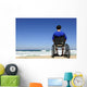 man in a wheelchair watching the sea Wall Mural