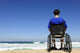 man in a wheelchair watching the sea Wall Mural