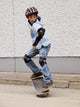 child skateboarding with helmet, knee pads and elbow protection Wall Mural