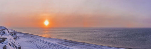 Sunset through windblown snow creates a sundog above the Beaufort Sea Wall Mural