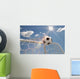 Soccer ball in the net on the sky background Wall Mural