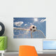 Soccer ball in the net on the sky background Wall Mural