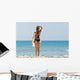 A woman wearing a black bikini stands Wall Mural