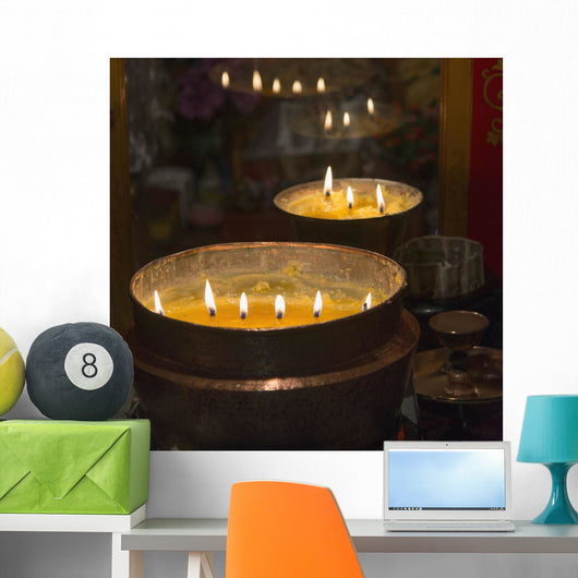 Flames burning in a row in large bronze pots;Lhasa xizang china Wall Mural