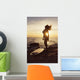 Silhouette of a woman standing on a rock Wall Mural