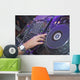 DJ mixing music on a mixer desk Wall Mural