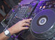 DJ mixing music on a mixer desk Wall Mural