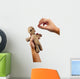 hands holding creepy voodoo doll with needles isolated on white Wall Decal