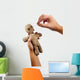 hands holding creepy voodoo doll with needles isolated on white Wall Decal
