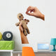 hands holding creepy voodoo doll with needles isolated on white Wall Decal