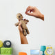 hands holding creepy voodoo doll with needles isolated on white Wall Decal