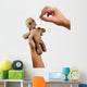 hands holding creepy voodoo doll with needles isolated on white Wall Decal