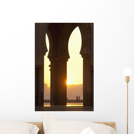 Morocco, Looking through arches of Hassan II mosque to couple chatting Wall Mural