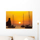 Spain, Yachts and strange shaped rock off Benirras beach at dusk Wall Mural