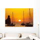 Spain, Yachts and strange shaped rock off Benirras beach at dusk Wall Mural