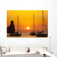 Spain, Yachts and strange shaped rock off Benirras beach at dusk Wall Mural