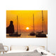 Spain, Yachts and strange shaped rock off Benirras beach at dusk Wall Mural
