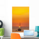 Spain, People watching sunset from yacht moored off Benirras beach Wall Mural