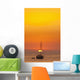 Spain, People watching sunset from yacht moored off Benirras beach Wall Mural