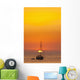 Spain, People watching sunset from yacht moored off Benirras beach Wall Mural