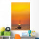 Spain, People watching sunset from yacht moored off Benirras beach Wall Mural