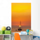 Spain, People watching sunset from yacht moored off Benirras beach Wall Mural