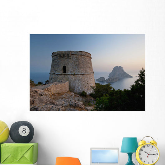Spain, Torre des Savinar and Es Vedra island at sunset Wall Mural