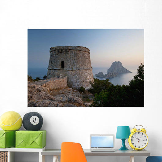 Spain, Torre des Savinar and Es Vedra island at sunset Wall Mural