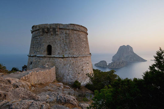Spain, Torre des Savinar and Es Vedra island at sunset Wall Mural