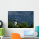 Germany, Stormy clouds behind Ruhpolding church Wall Mural