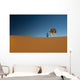 Berber leading camel across sand dune near Merzouga in Sahara Desert Wall Mural