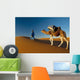 Berber leading camel across sand dune near Merzouga in Sahara Desert Wall Mural