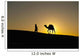 Silhouette of Berber 'Blue man' leading camel across sand dunes Wall Mural