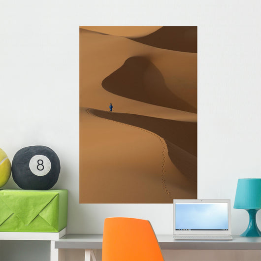 Berber 'Blue man' walking across sand dunes in Erg Chebbi area Wall Mural