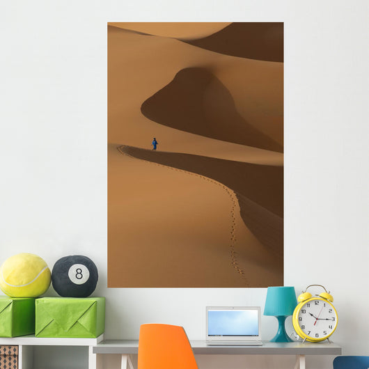 Berber 'Blue man' walking across sand dunes in Erg Chebbi area Wall Mural