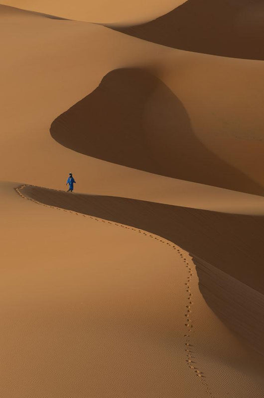 Berber 'Blue man' walking across sand dunes in Erg Chebbi area Wall Mural
