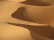 Berber 'blue man' walking through sand dunes in Erg Chebbi area Wall Mural