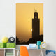 Morocco, Sun setting behind minaret of Koutoubia mosque Wall Mural