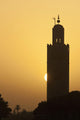 Morocco, Sun setting behind minaret of Koutoubia mosque Wall Mural