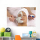 spa esthetician applying organic facial masque Wall Mural