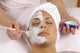 spa esthetician applying organic facial masque Wall Mural