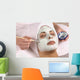 spa esthetician applying facial masque Wall Mural