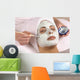 spa esthetician applying facial masque Wall Mural