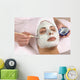 spa esthetician applying facial masque Wall Mural