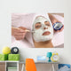 spa esthetician applying facial masque Wall Mural